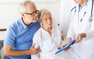 medicine, age, health care and people concept - senior woman, man and doctor with tablet pc computer at hospital ward