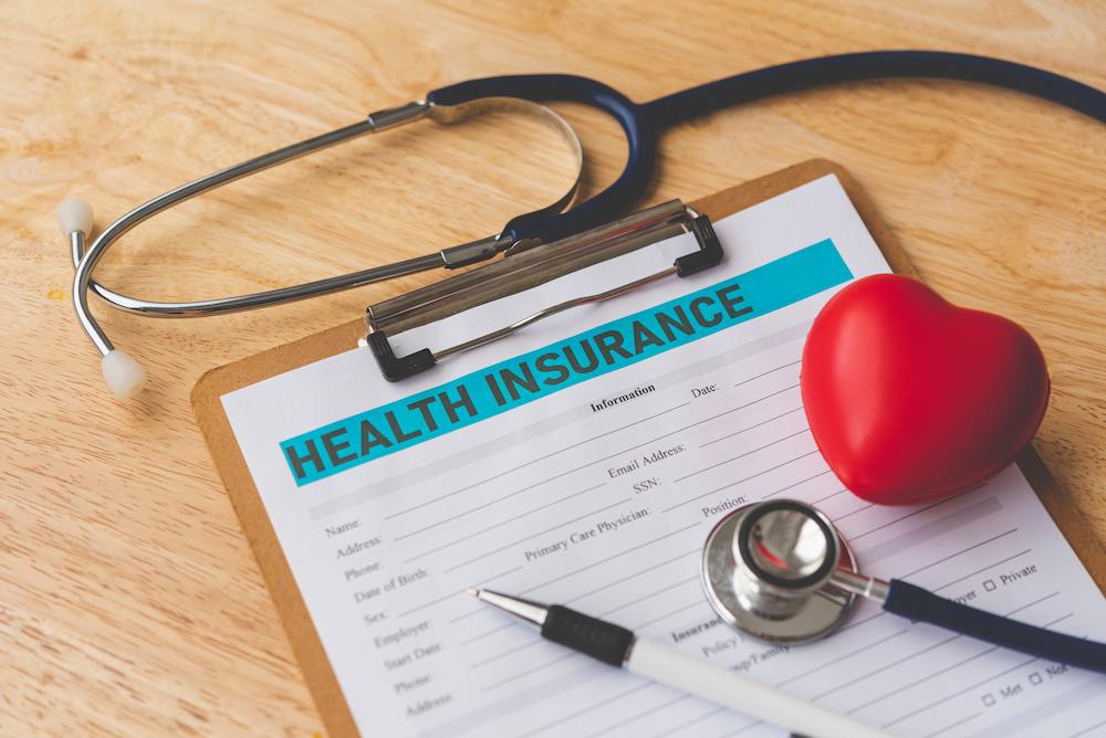 Work with Nefouse & Associates to secure your best Indiana Group Health Insurance deal image shows clipboard and stethoscope