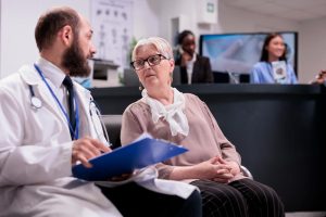 Many Hoosiers face increased Indiana Health Insurance costs due to ACA subsidies expiring image shows doctor speaking with woman
