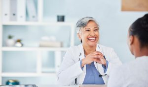 Discuss Indiana Group Health Insurance with Nefouse & Associates image shows doctor speaking with visitor in office