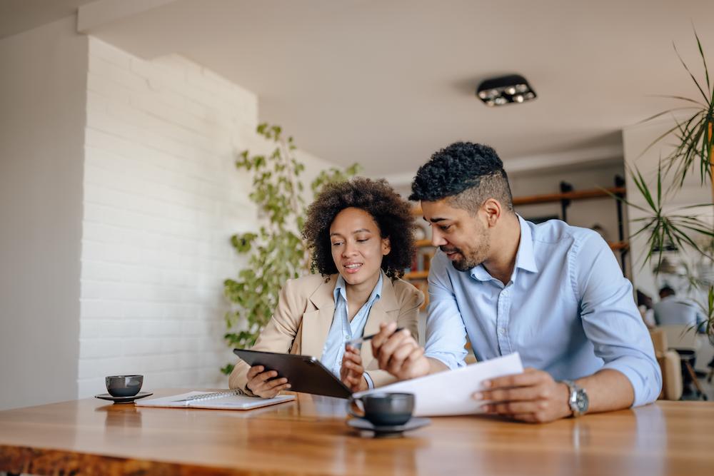 image shows couple reviewing information on tablet