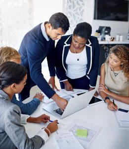 Consider level funding for Indiana Group Health Insurance image shows team studying information at table